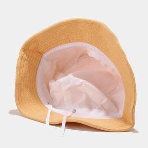 Yellow towel fabric bucket hat with adjustable inner drawstring lining and knit texture