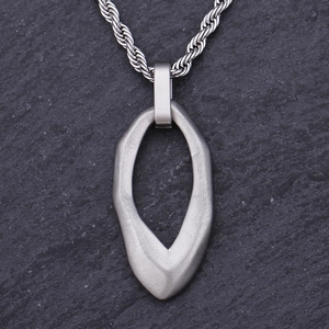 Close-up of vintage irregular water drop titanium steel pendant with silver twist chain