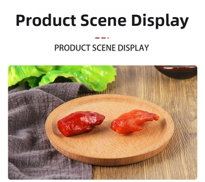 Detailed close-up of realistic faux braised chicken wing model on a wooden plate
