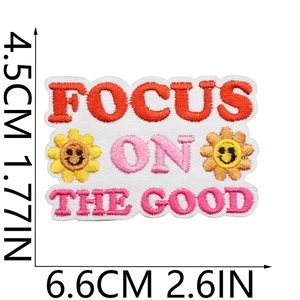 Detail view of Focus On The Good embroidered patch with dimensions 6.6cm by 4.5cm