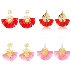 Bohemian fan-shaped tassel earrings with gold sunburst design and pearls on white base