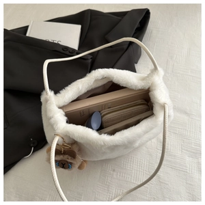 Spacious white plush tote bag with interior view showing books and bear charm detail