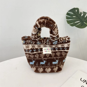 Detailed close-up of plush tote bag texture with brown patterns and cute deer elements