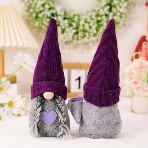 Pair of festive purple knitted gnomes with gray felt bodies for holiday home decoration