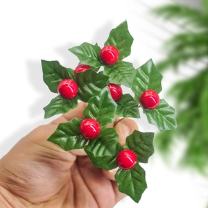 Handheld artificial holly branch with red berries and green serrated leaves for Christmas decor