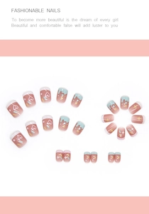 Macro detail of cute pink and blue press-on nails with heart and drip designs
