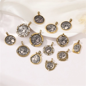 Ancient Greek coin pendants in gold and silver finish with pearls on white fabric