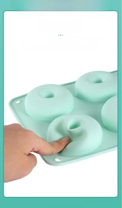 Close-up of flexible green silicone donut mold showing soft food-grade material