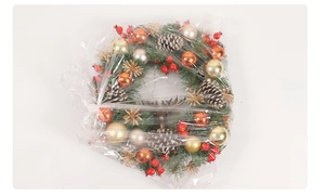 Detailed view of Christmas wreath featuring red berries, pine cones, and gold ornaments