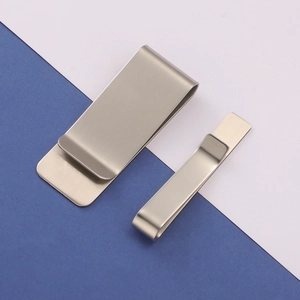 Detail view of silver brushed stainless steel tie clips in two sizes on blue background
