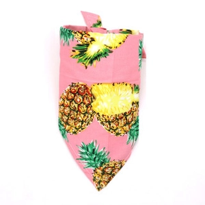 Detailed close-up of a pink cotton pet bandana with vibrant yellow pineapple print