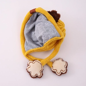 Detail of yellow knit toddler winter hat with grey cotton lining and cute paw prints