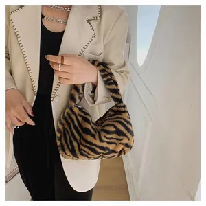 Detailed view of plush tiger print faux fur handbag with stylish brown and black texture