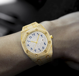 Detail of gold luxury watch with full diamonds and Arabic numerals dial