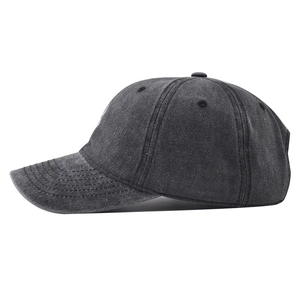 Close-up of vintage washed denim baseball cap with spider embroidery and curved brim