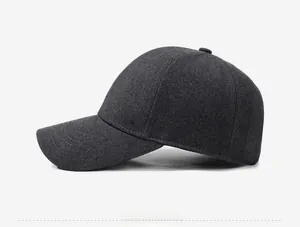 Détail de la casquette de baseball en laine gris foncé montrant la texture et le logo métal
