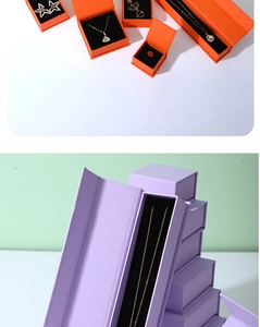 Detail view of magnetic jewelry boxes in orange and lavender for rings and necklaces