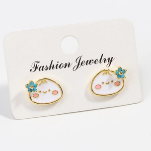 Detail of white enamel bun stud earrings with blue flowers on fashion jewelry card