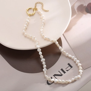 Detailed close-up of baroque freshwater pearl necklace with gold-plated spring clasp hardware