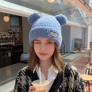 Cute light blue plush knitted winter hat with bear ears and warm fleece for women
