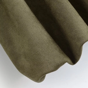 Macro detail of military green suede jacket fabric showing pleated hem and premium texture
