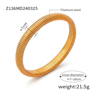 Detailed view of wide 1cm golden titanium steel spring bracelet with size measurements