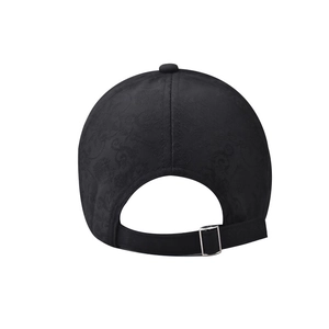 Detail of black cotton baseball cap showing floral jacquard texture and metal buckle