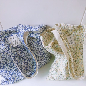 Detail of floral canvas tote bags in blue and yellow patterns with large capacity