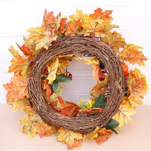 Fall wreath with maple leaves, pumpkins and pine cones for Thanksgiving door decor