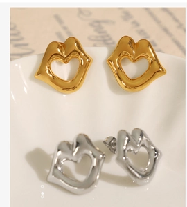 Detailed view of 18k gold and silver plated stainless steel lip-shaped heart earrings