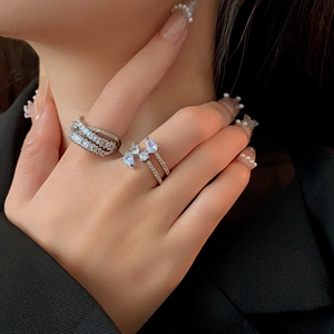 Close-up of silver layered ring set with sparkling cubic zirconia on a model's hand