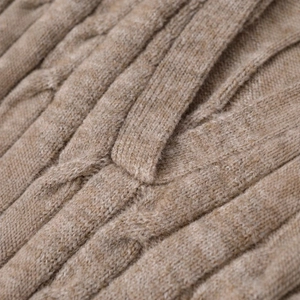 Close-up of brown cable knit pattern on a warm V-neck long sleeve polo sweater