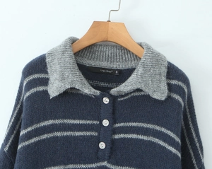 Detail of navy blue and grey striped knit sweater with polo collar and three pearl buttons
