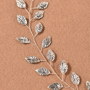 Detailed close-up of silver leaf vine bridal headband with delicate metal textures
