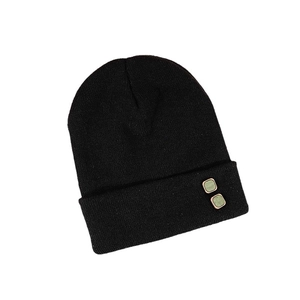 Black knit beanie featuring stylish green square buttons and warm winter fabric