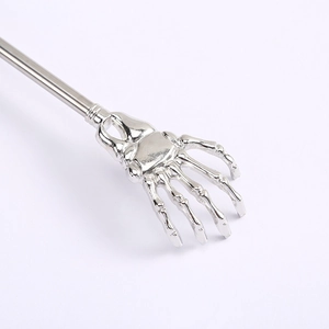 Silver stainless steel telescopic back scratcher with skeleton claw design on white backdrop