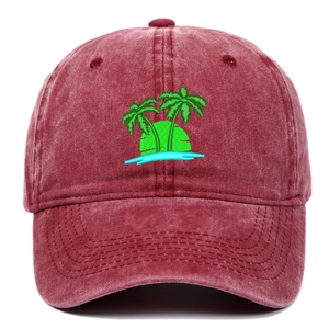 Detail of green palm tree embroidery on washed red vintage cotton baseball cap