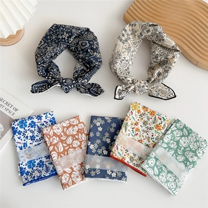 Collection of printed cotton neckerchiefs with paisley and floral patterns on white background