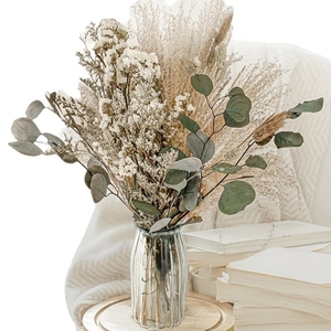 Preserved flower bouquet with white gypsophila and eucalyptus in a clear glass vase