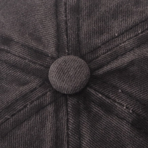 Macro detail of the corduroy fabric texture and stitched top button on the vintage baseball cap