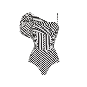 Detail of one-shoulder striped swimsuit with elegant ruffle trim and monochrome pattern