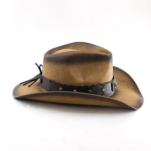 Detail of cowboy straw hat with leather band, metal studs and golden star emblem