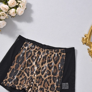 Detail of sequin leopard print shorts with mesh panels and S size tag on gray background