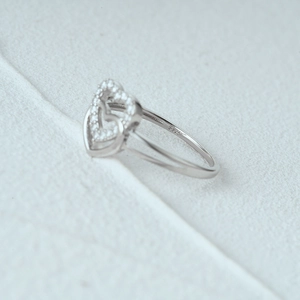 Macro shot of S925 sterling silver ring showing double heart design and hallmark engraving