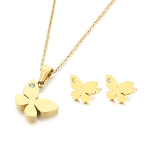 Golden butterfly necklace and earrings set with sparkling crystals on white background