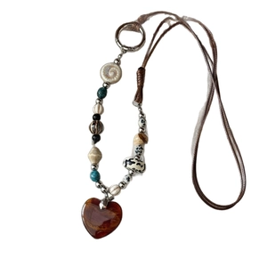 Vintage necklace with amber heart pendant and ceramic stone beads on a brown cord