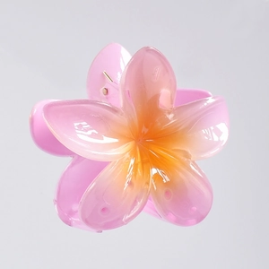 Detail of pink gradient plumeria hair claw clip with glossy resin flower petals