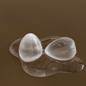 Macro view of transparent egg-shaped mold with ice-like texture on a leather surface