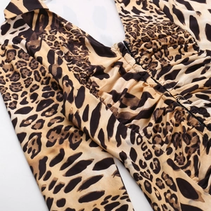 Detailed view of the leopard print fabric featuring a deep V-neck and ruched chest design