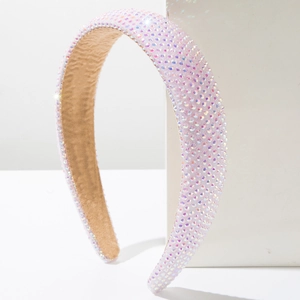 Close-up of luxury sponge headband with sparkling rainbow rhinestones on white cube
